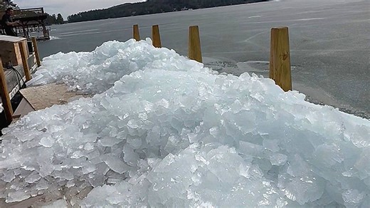 Ice appears to climb a ramp onto a dock - and there's a good reason why