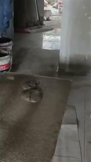 a man pouring mortar to install ceramic tiles