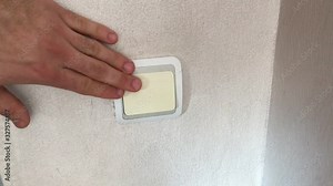 male hand turns on off the light switch