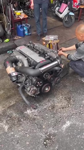 Hands-On Car Engine Repair in Outdoor Workshop