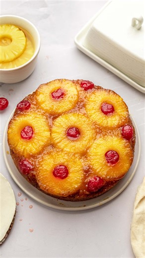 This vegan pineapple upside down cake is like a buttery tropical dream! Sweet juicy and caramelised pineapples sit on top (or underneath) a soft buttery cake with the most heavenly crumb. The cake itself contains pineapple juice, which is very acidic and gives it a more tender crumb! I love that this cake is easy to make and you don't need to bother with any fancy decorations/frosting. Recipe is in the comments x | Rainbow Nourishments