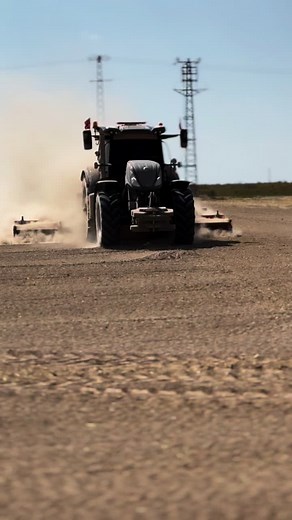 Powerful Tractor in Action: Farming on Dusty Fields