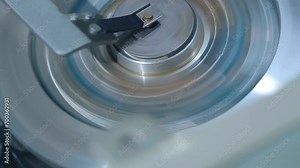 The VCR head rotates, removing information from the magnetic tape, turning magnetic induction into pictures on the TV screen. Shot in motion. Closeup. Macro. Shallow depth of field