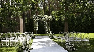 a beautiful arch for a wedding ceremony in a park with chairs