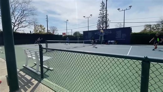 Natural Tennis player and owner Brian Battistone hitting the jump serve with The Freestyle two-handled tennis racket. NATURALTENNIS.com | Natural Tennis