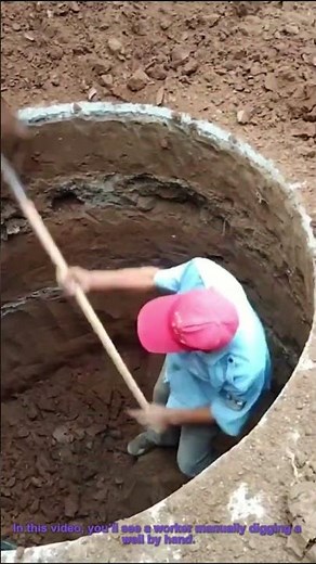 Manual Well Digging: Worker Excavates by Hand