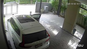 Mother rushes over to rescue son stuck in automatic gate