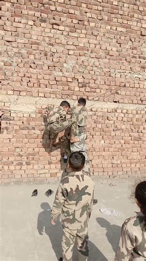 Students training of Commando School system how to climb on a high wall
