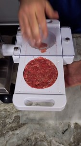 The device shown is a manual burger press, used to form uniform burger patties from ground meat. It works by loading the meat into a mold, pressing it to create a consistent shape and size, and then ejecting the patty. This tool ensures even cooking, speeds up the patty-making process, and reduces direct handling of the meat, making it popular in both professional kitchens and home cooking. #burger #burgerpatty | Adam Schihab