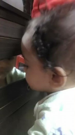 baby girl kissing to mirror