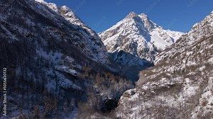 Mont Pelvous in Ecrins Natlional Park. Aerial view of snow covered mountain peaks with frozen forest. Winter in Vallouise and Ailefroide Valley, Hautes-Alpes (Alps) France