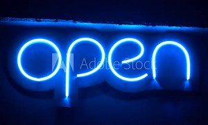 Blue neon sign changing brightness with inscription Open. Neon - chemical element, inert gas, it has symbol Ne and atomic number 10. It is the second noble gas in periodic table