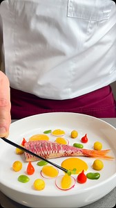 This exquisite dish is a symphony of flavors and textures. The pan-seared red mullet is perfectly cooked, with a crispy skin and moist, flaky flesh. The shrimp velouté is rich and creamy, enhancing the natural sweetness of the fish. The marinated peppers add a touch of acidity and freshness, while the golden crispy potatoes provide a satisfying crunch. The delicate touch of pike caviar elevates the dish with its briny, salty flavor. Hashtags: * #RedMullet * #Seafood * #FineDining * #ExquisiteDis