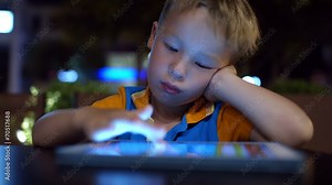 Bored little boy using pad in cafe Stock Video