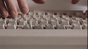 Computer engineer developer is working on old vintage computer 1990s. Antique classic pc keyboard and programmer typing hands. Internet web digital startup history. Outdated retro technology concept