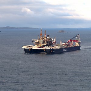 A giant oil platform has arrived in Shetland on board one of the world's biggest ships. | BBC Scotland News