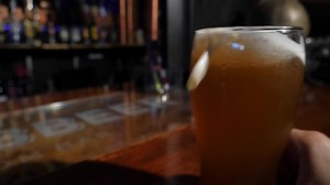 Slow motion shot of a beer sliding over the bar