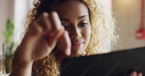 Mixed race teenager using ipad tablet computer touchscreen in cafe