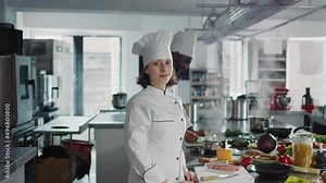 Authentic portrait of female chef preparing food in restaurant kitchen, making professional cuisine dish with gourmet recipe and organic ingredients. Confident woman cooking delicious meal.