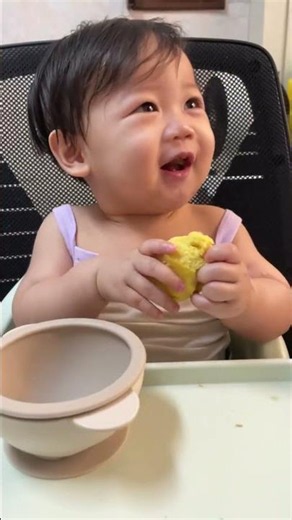 Casper gnawing a steamed bun, smiling and giggling with a magical charm!
