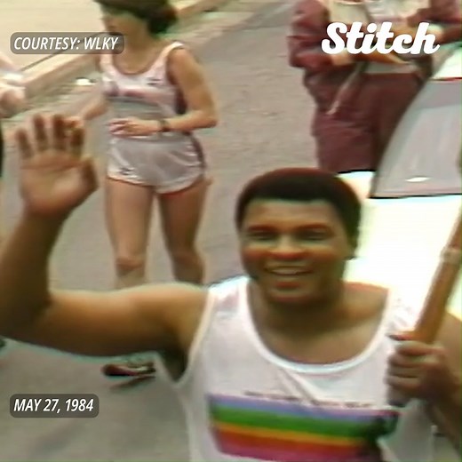 CARRYING THE OLYMPIC TORCH: "The Greatest" Muhammad Ali was among eleven runners in 1984 that carried the Olympic torch in a traditional relay through the streets of Louisville, Kentucky. Thousands lined the street to witness the legend. | Hearst Television
