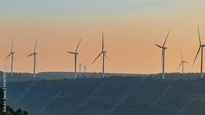 Time lapse of wind turbine for generating electricity from wind power with beautiful sky in sunset time