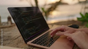 Female developer working on laptop creating apps by the ocean. Young woman freelancer coding at outdoor tropical cafe. Caucasian girl working remotely at exotic location. Worldwide work concept