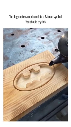 @top.zone800 | The post showcases a 19-second video of a DIY project carving a Batman symbol into wood, pouring molten aluminium to cast it, then sanding... | Instagram