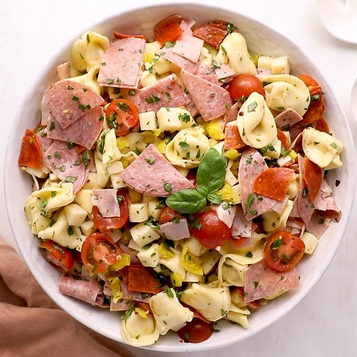 Tortellini salad loaded with salami, capicola ham, pepperoni, fresh mozzarella cheese, homemade basic Italian dressing and much more. You can easy make it ahead of time or right before the party. It really is a perfect pasta salad to take with your on a picnic. GET MY FULL RECIPE: https://www.willcookforsmiles.com/italian-tortellini-salad/ | Will Cook For Smiles