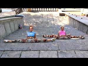 Training splits on the street. Two flexible girls. Contortionist Alesya and ballerina Rimma.