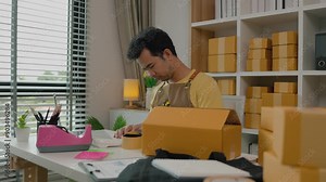 An entrepreneur is running his online small business, his preparation helped him a lot in filling out the information on the parcel, written to sort the order of products in the package.