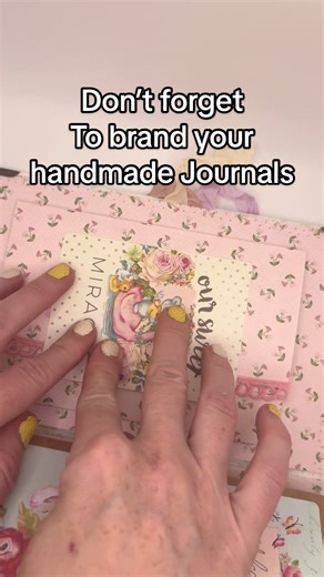 Final touches on a handmade journal for a baby shower gift | Journal