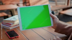 In cafe hand woman sitting use tablet computer with horizontal green screen typing display internet touchpad connection touchscreen communication chroma finger message mobile slow motion