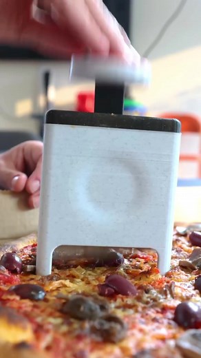 The Slice Slapper™️ Eliminate horrible pizza toppings in an instant! Our debut removal tool features an easy push button and tri-angled blades to rapidly chop away any potion of your pizza pie featuring ingredients you would NEVER eat. Simply locate the deplorable section and slap it away to customize your pizza to your unique one of a kind taste. Now… who TF ordered the pineapple olive mushroom pizza?!? | Unnecessary Inventions