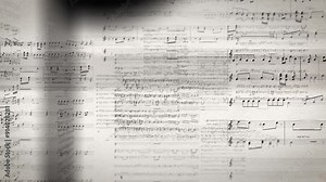 Seamless loop of a movement through musical notes on individual sheets of music, inside music, animation