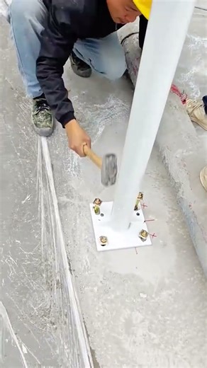 Installing White Post Base with Anchor Bolts and Sledgehammer