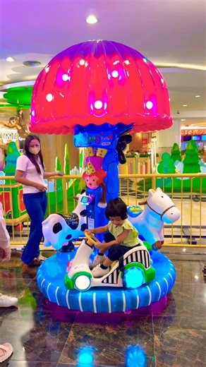 A cute carousel under pink and blue trees with cars, horses, and cows?! You have to see this! 🌸🐎🐄