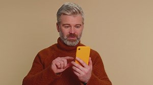 Happy excited old man use smartphone say wow yes found out great big win news doing winner gesture