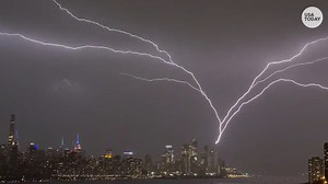 New York City skyline lit up by upward lightning during powerful storm