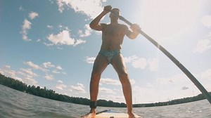 clip-1077785897-guy-confidently-rides-on-board-paddle-sapboard