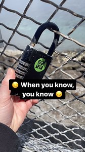 😏 When you know, you know 😏 Would you spot this cache? 🔎 Video by mostly_moss. Video: The camera pans across dozens of padlocks locked to a metal fence on a bridge. A geocacher reaches out and turns a lock over to reveal a sticker with the Geocaching® logo. #geocaching #geocache #awesome #trending #hiddeninplainsight | Geocaching