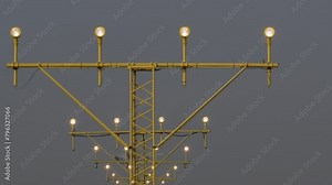 Airplane captured mid-descent over runway approach lights, undercarriage deployed for landing