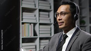 Telephone operator works with computer in office and talks with customers.