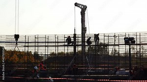 working people at the top perform assembly work with fittings