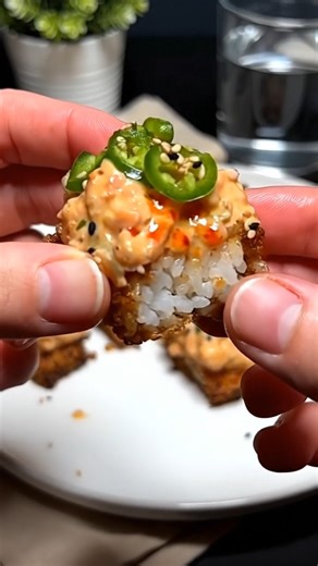 Spicy Salmon Crispy Rice Crispy on the outside, tender on the inside, and topped with silky spicy salmon—this bite-sized favorite delivers bold flavor in every crunch. Ingredients For the Crispy Rice 2 cups cooked sushi rice (cold) 1 tbsp rice vinegar ½ tsp sugar ½ tsp salt Vegetable oil, for frying For the Spicy Salmon 8 oz (225 g) fresh salmon, finely diced 2 tbsp mayonnaise (Japanese preferred) 1–2 tsp sriracha (to taste) 1 tsp soy sauce ½ tsp sesame oil For Topping & Garnish Jalapeño slices 