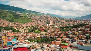 Medellin, Colombia, time lapse view over the famous Comuna 13 slums during daytime. Zoom out.