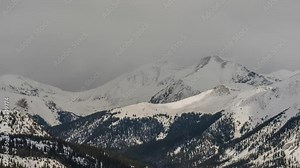 Rocky Mountains spring afternoon clouds rolling Timelapse Colorado Keystone Breckenridge Montezuma Loveland Pass Vail Copper Mountain Continential Divide snow peaks slowly afternoon daytime zoom out