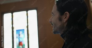 Christian pastor preaching, teaching, delivering sermon in church holding bible.