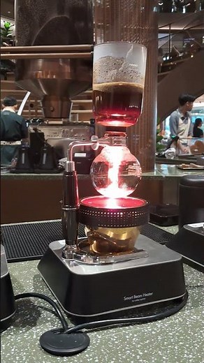 Coffee brewing by syphon at the brand new flagship store of Cafe Amazon Experience in Ari, Bangkok
