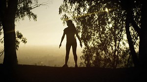 Woman exercising in park and doing low squats, fitness, exercising, healthy lifestyle, training